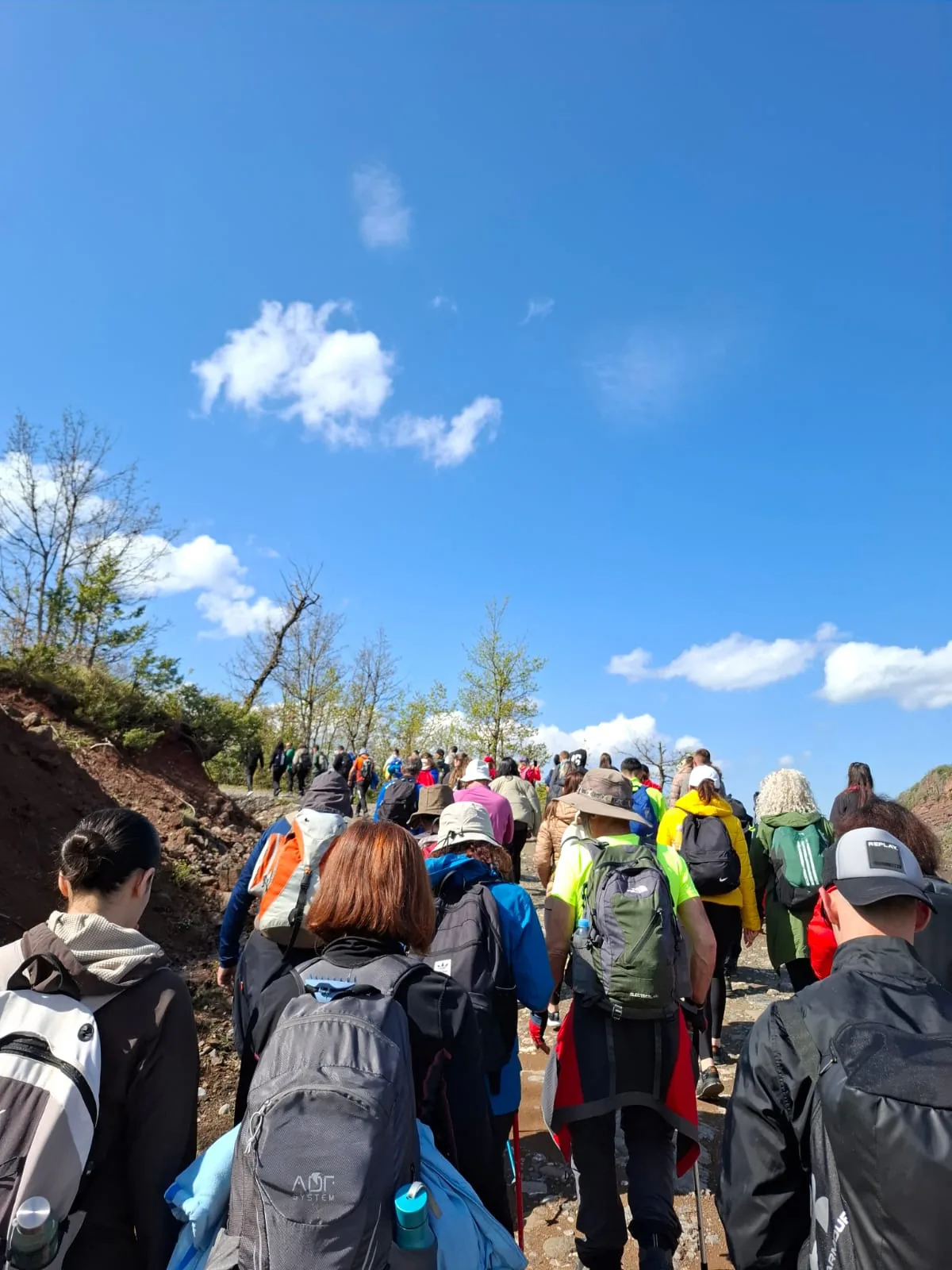 Hikers ascending a spring trail